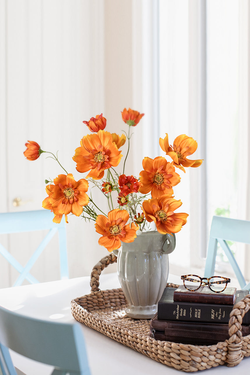 Vibrant orange artificial Cosmos Sulphureus silk flower blooms enhance home decor with their captivating beauty and everlasting charm.