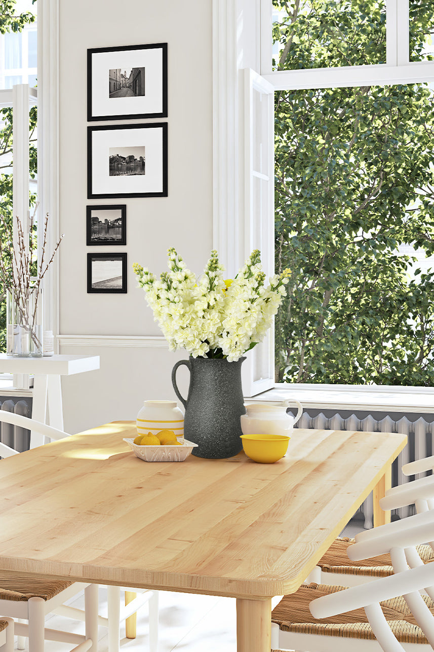 An artificial matthiola incana flower in cream white color on a dining table with a floral vase