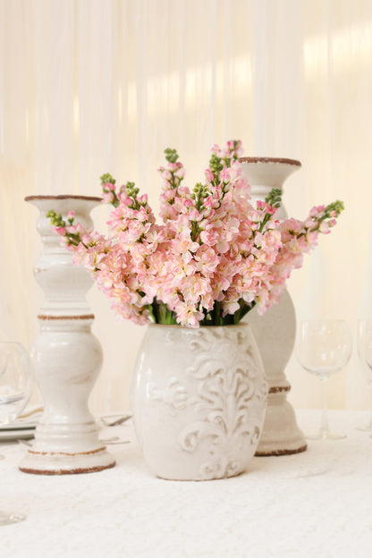 Enhance your dining room ambiance with the soft, warm glow and lifelike beauty of mauve pink fake Matthiola Incana flowers.