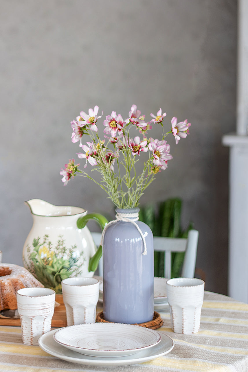The white-pink artificial cosmos is placed in a ceramic vase, which brings a fresh feeling and becomes the choice of people&