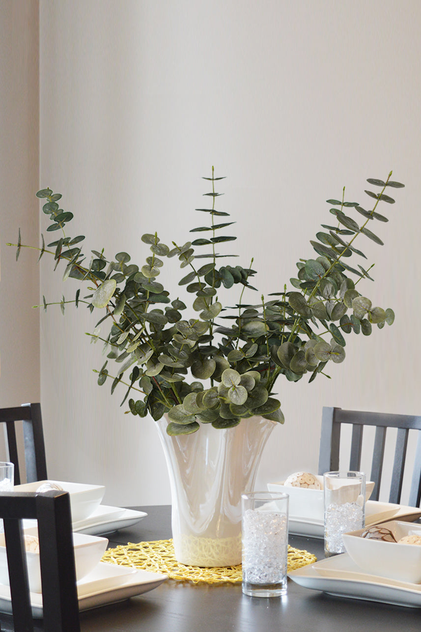 Enhance your space with the timeless beauty of our artificial spiral eucalyptus displayed in an elegant white vase.