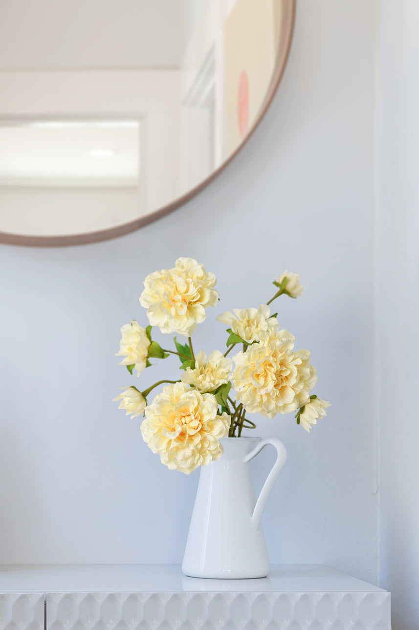 Yellow peach Paeonia silk flower enhances the living room decor, radiating warmth and elegance with its vibrant hues.