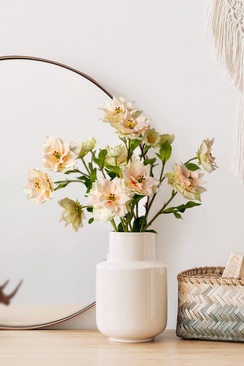 The lifelike soft blush-peach Clematis fake flowers arrangement brings delicate beauty to any dressing table decor.