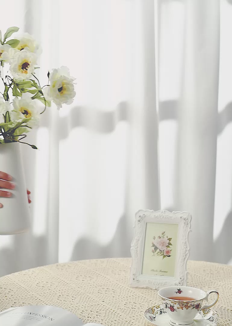 The artificial lotus crane peony flower floral arrangement against a white or retro background exudes a sense of graceful tranquility and timeless beauty.
