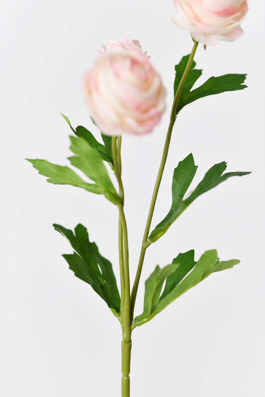 Life-like artificial silk flowers in light pink with bright green leaves, creating a realistic effect