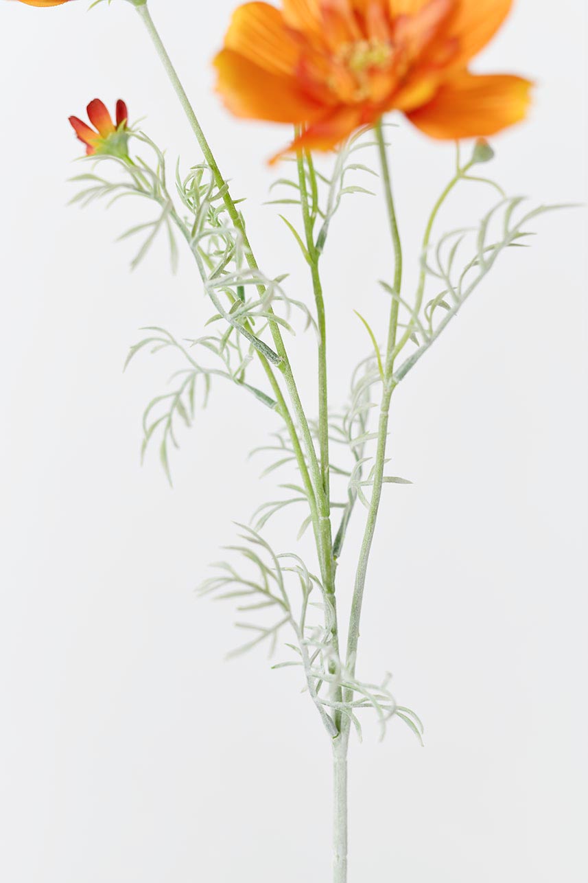 A detailed description of the artificial stems and leaves of orange Cosmos sulphureus, adding a touch of nature to any home decor.