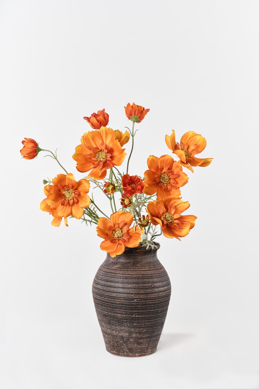 A stunning arrangement of faux orange Cosmos sulphureus blooms and buds, bringing the beauty of the outdoors inside.