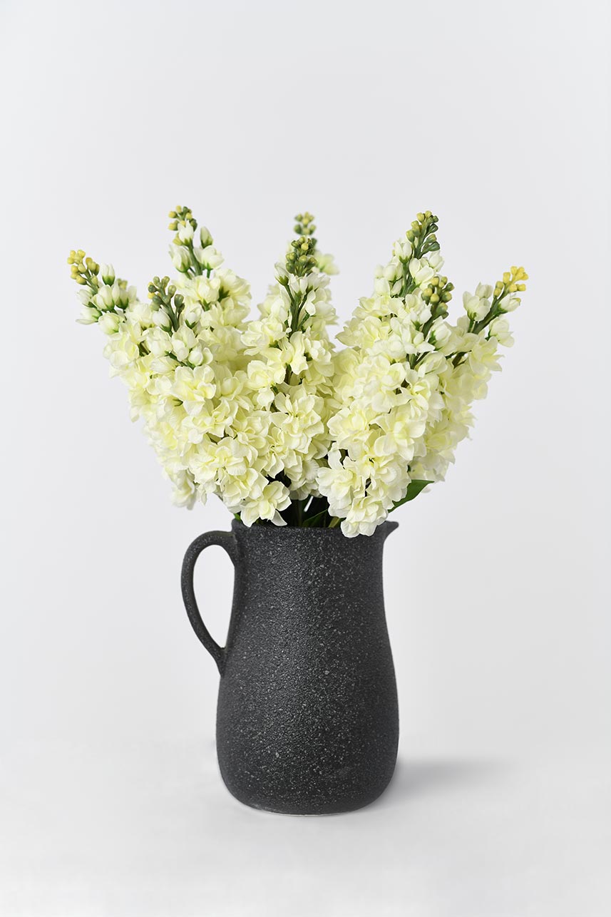 A cream white artificial matthiola incana flower that is perfect for home decor