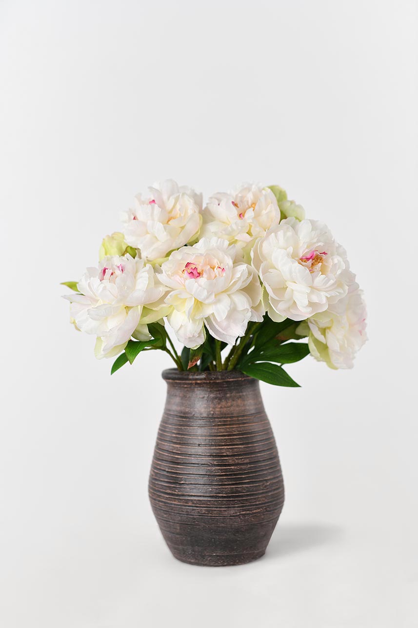Artificial phoenix peony blooming in varying stages of maturity, arrange in a brown ceramic vase, completes its elegance quite nicely.