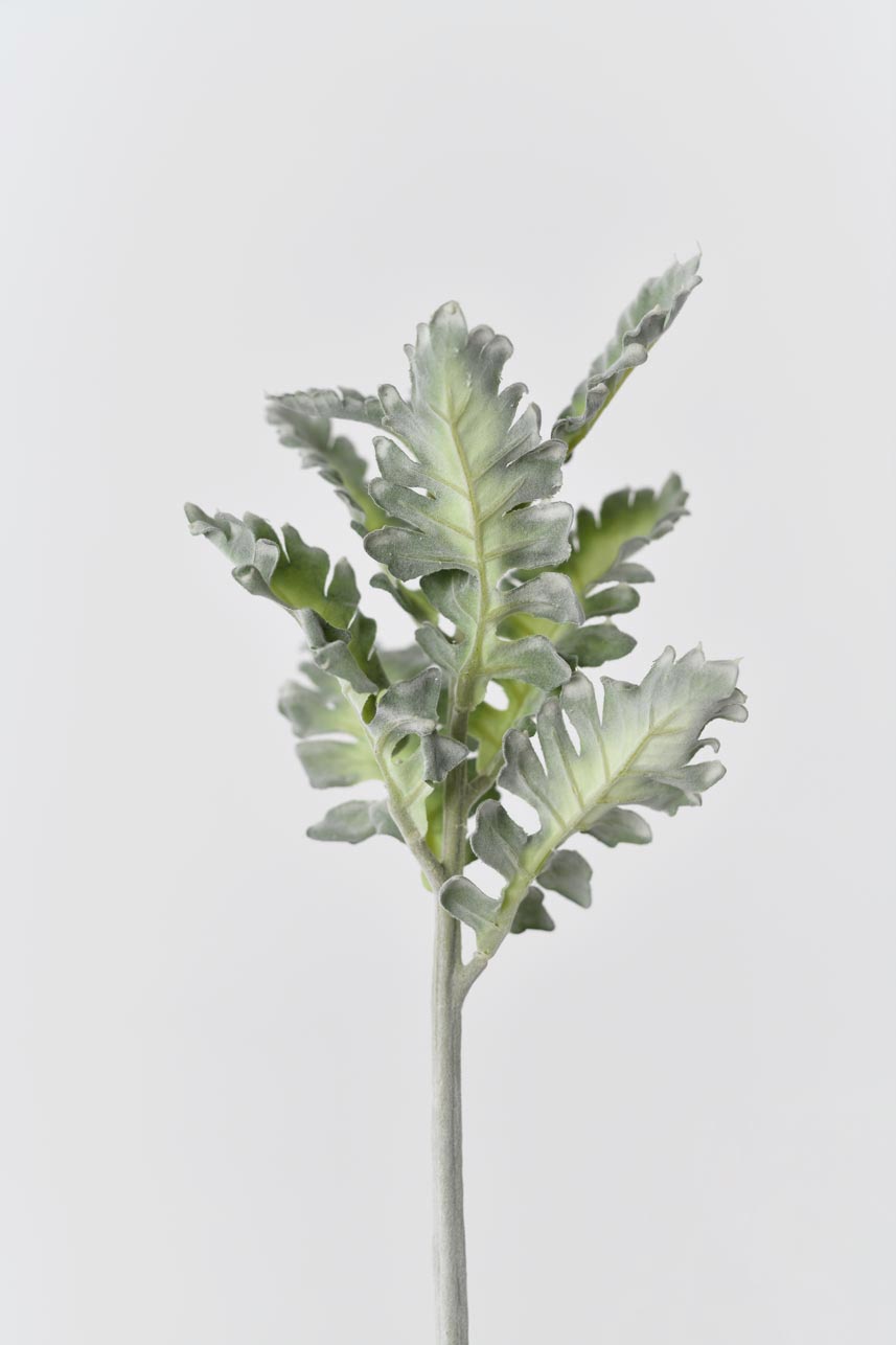 A small potted artificial plant with faux Senecio Cineraria in shades of green. The leaves are textured and realistic, adding depth and a natural feel to the arrangement.