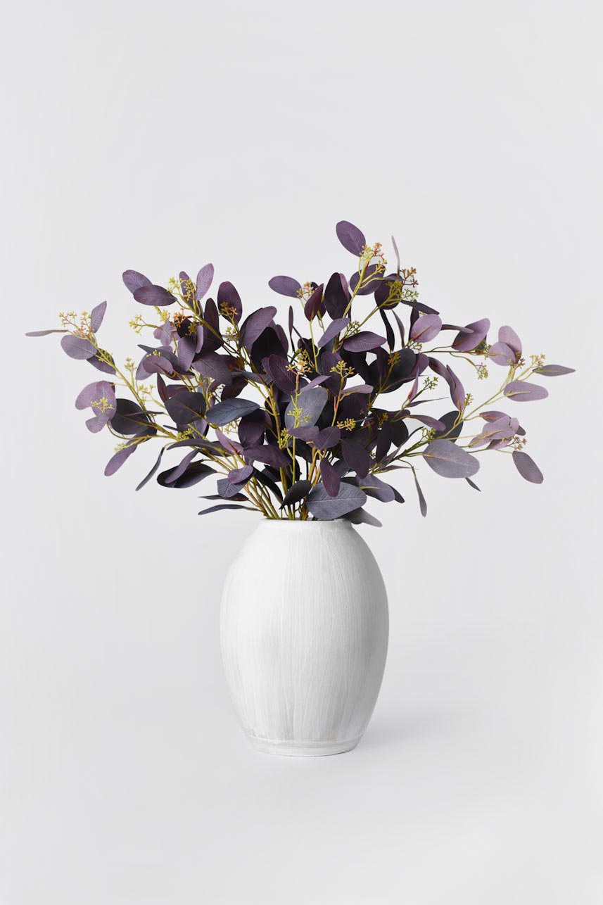Artificial real-looking artificial Burgundy Parisian Eucalyptus arrangements in a big vase, adding natural charm to any space.