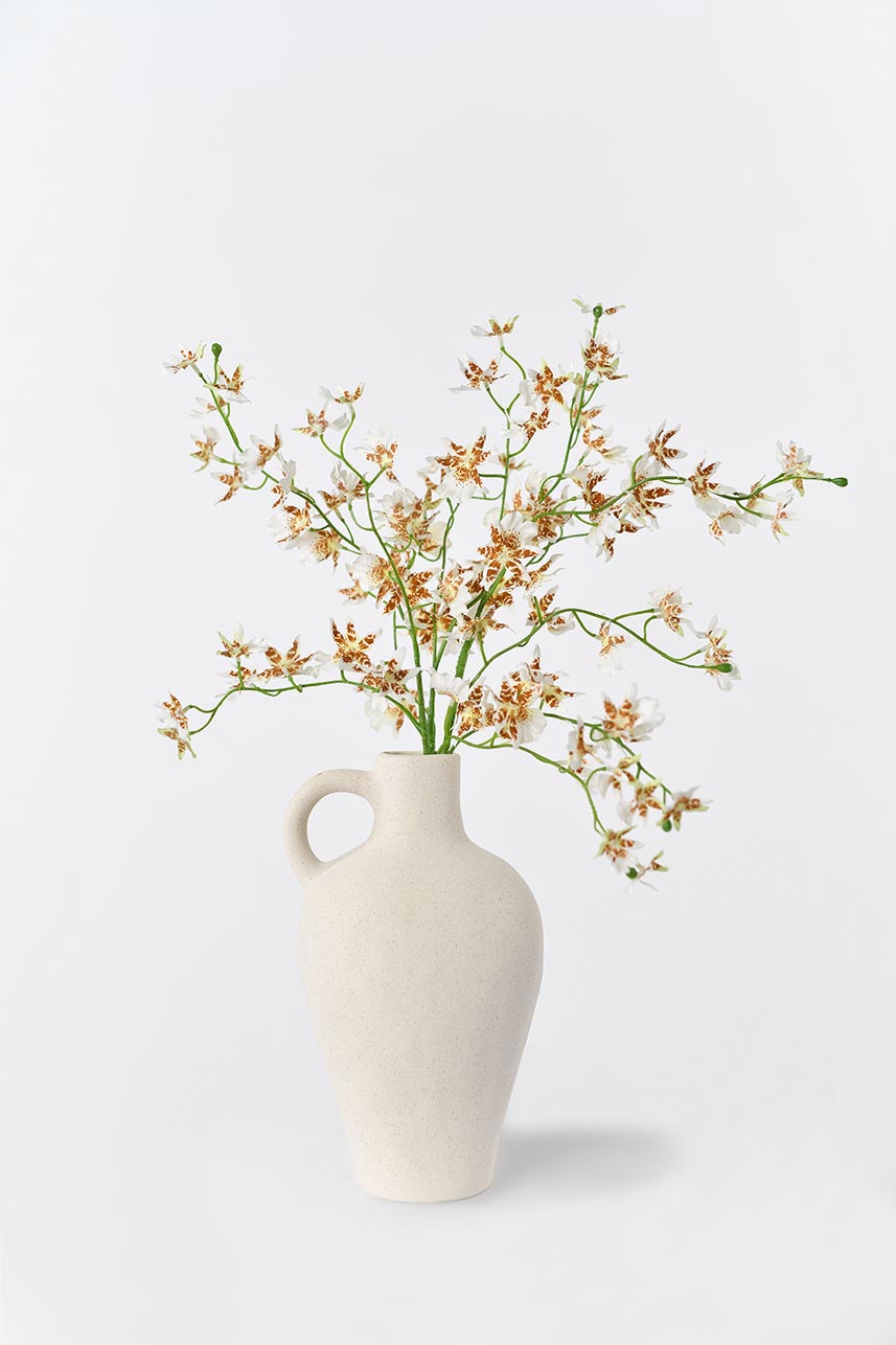 Silkfloras fake blooming cream white oncidium silk flowers in a white vase, a stunning and lifelike floral arrangement.