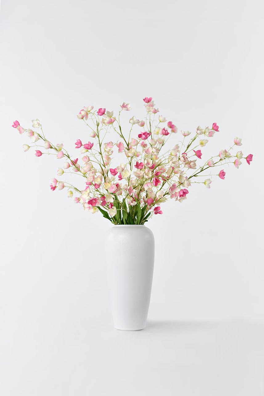 Artificial Enkianthu flower in full bloom, arranged in a white vase