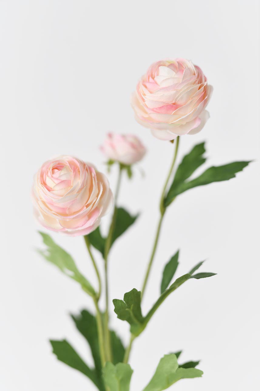 Faux silk flowers in light pink with bright green leaves and realistic petals textures
