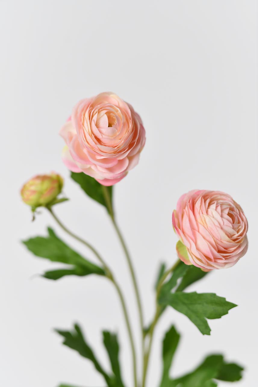 Faux silk flowers in rose pink with bright green leaves and realistic petals textures