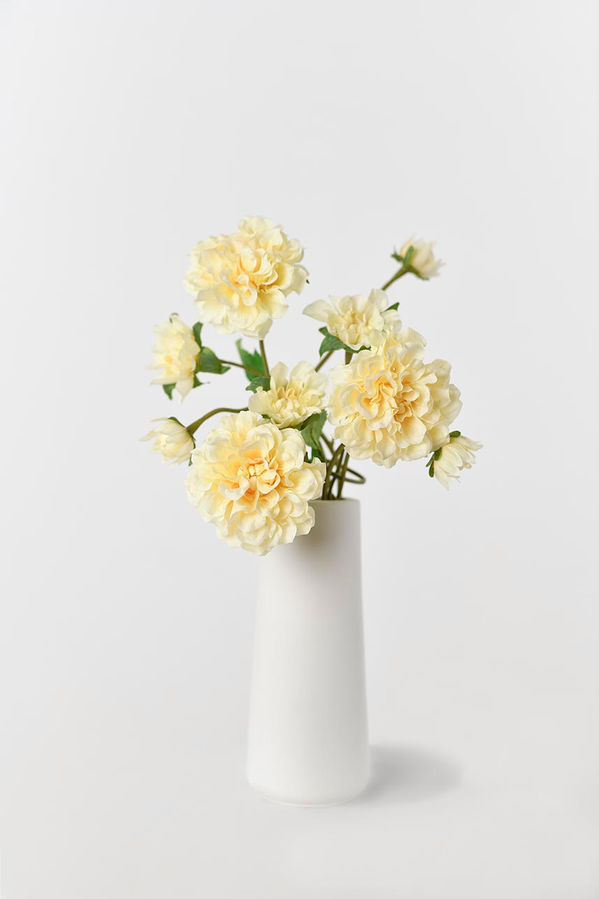 A beautiful silk Paeonia in yellow and peach colors with lifelike petals, arranged in a vase for an eye-catching display. Perfect for home decor or special occasions.