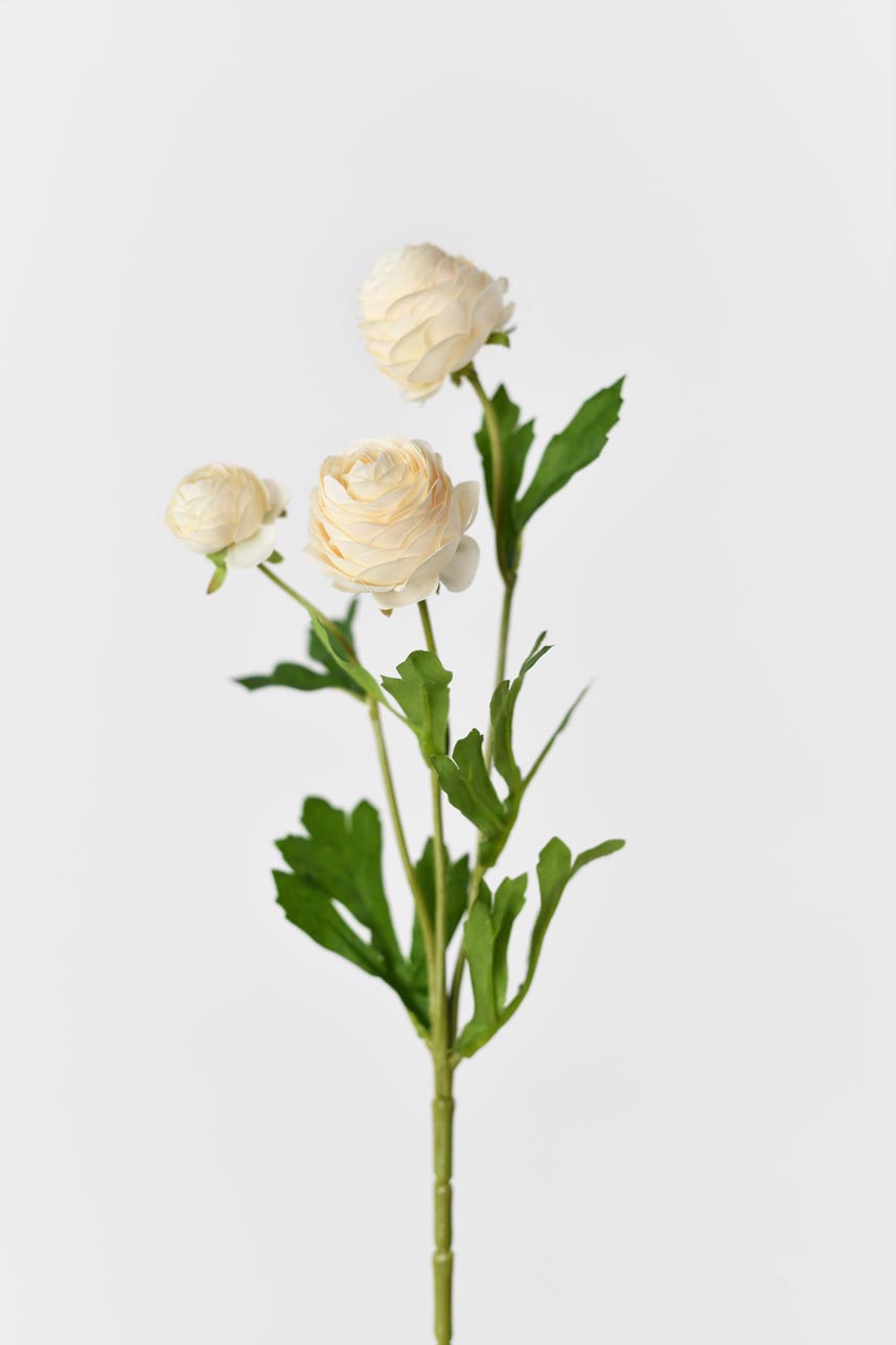 Realistic artificial silk flower in yellow peach with bright green leaves and petals