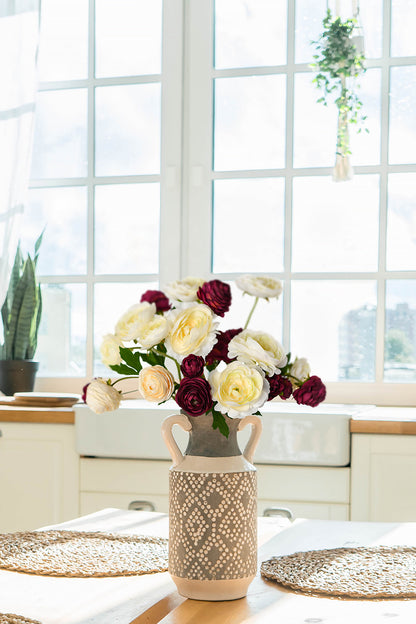 Artificial ranunculus have a fresh appearance, with mahogany flowers, so that the overall look has a vintage feel.