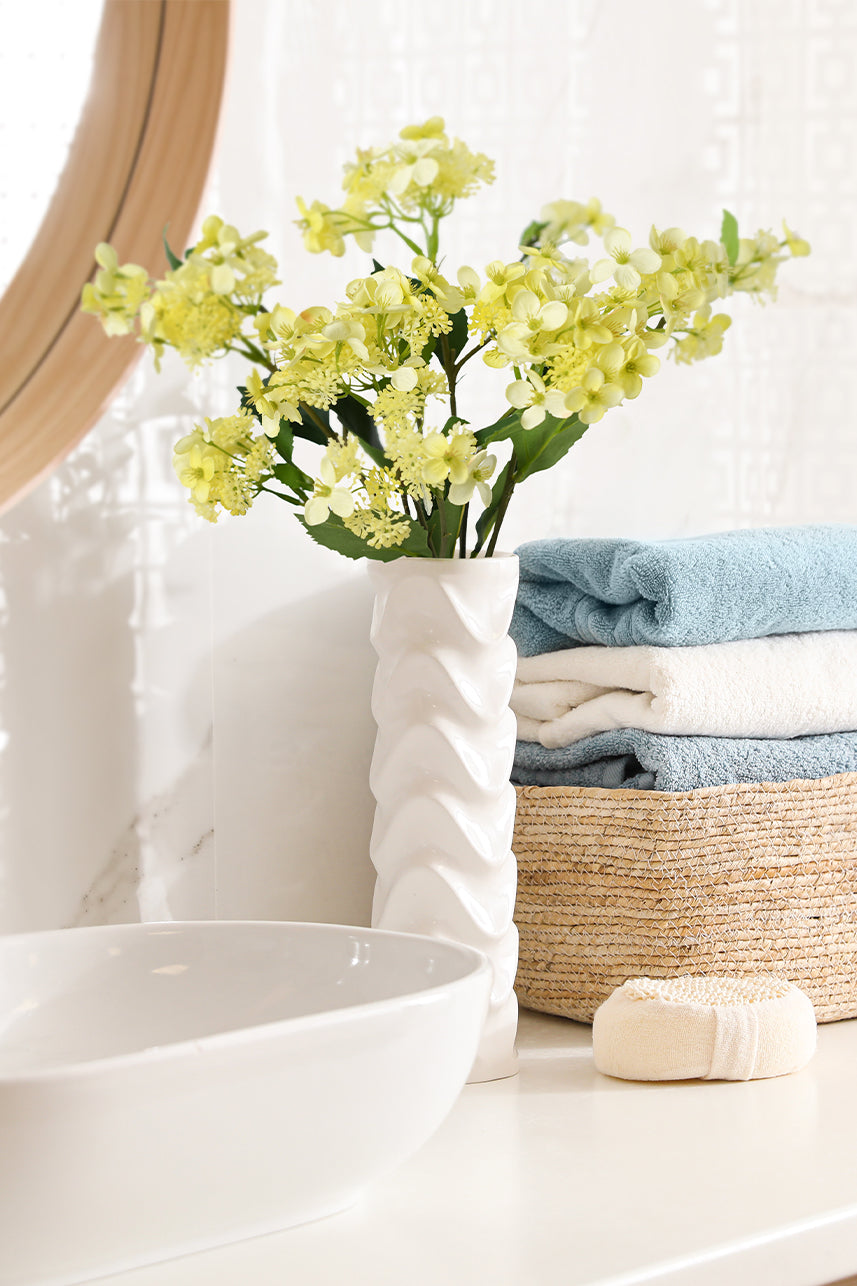 Yellow artificial Hydrangea Hortensia flower adds a burst of vibrant beauty to bathroom decor, infusing the space with sunny charm and refreshing energy.