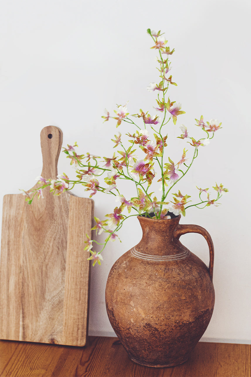 Artificial oncidium with slender stems seem to be more suitable for unique shapes, and you can place it in a suitable vase.