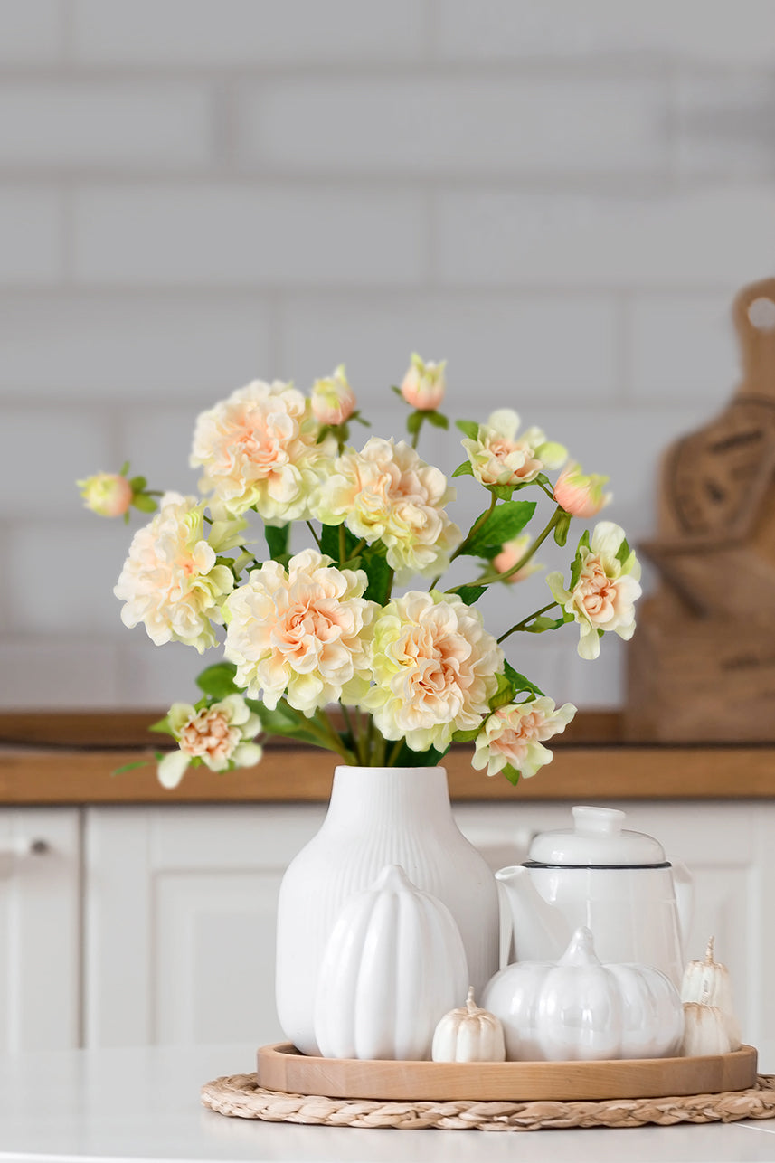 Lifelike blush-peach artificial paeonia blooms in a soft blush peach shade, adding elegance and charm to any setting.