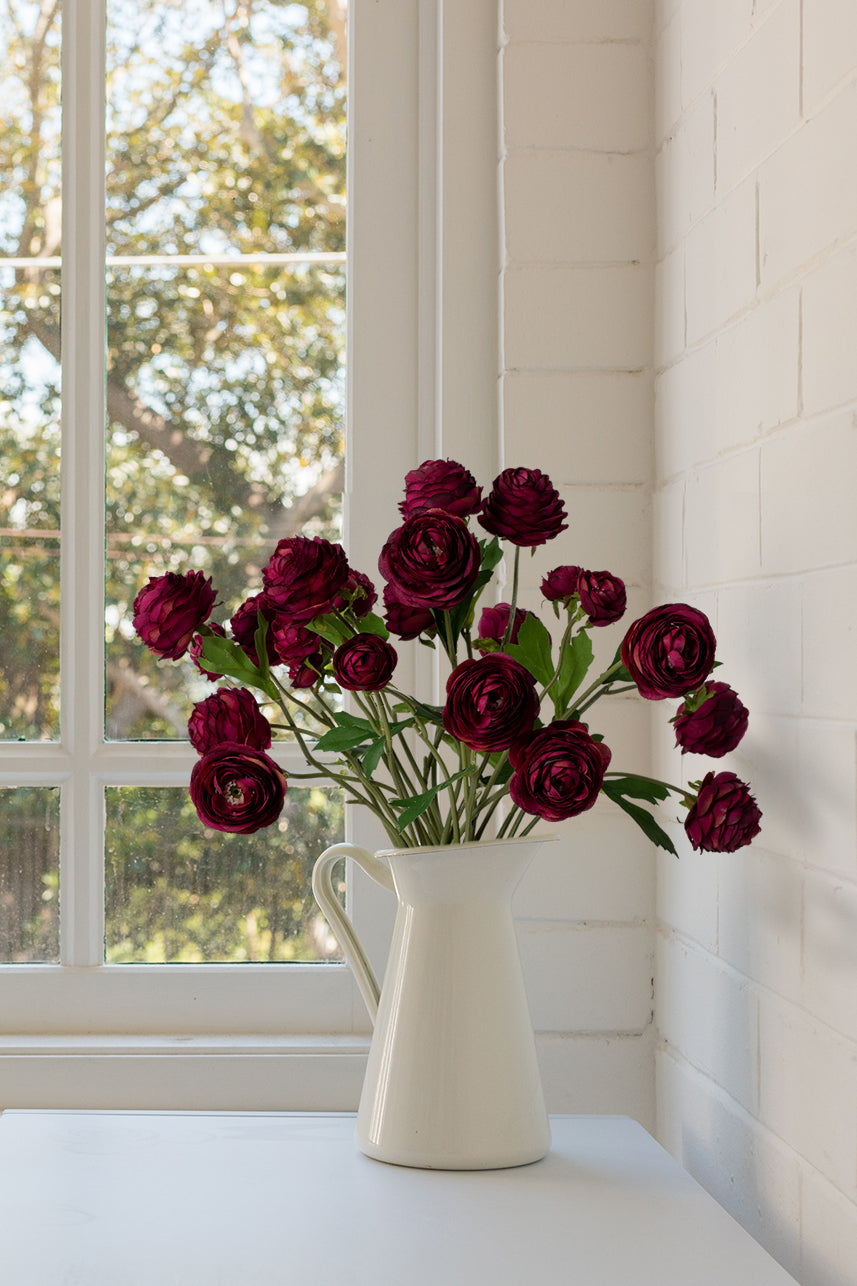 Each artificial ranunculus flower in this arrangement is meticulously designed to replicate the intricate layers of petals and vibrant color of the natural blossoms.