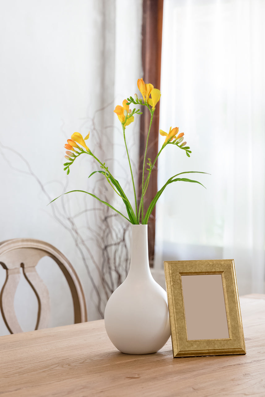 Classic farmhouse decor comes alive with the vibrant presence of orange artificial Freesia flowers, exuding rustic charm and natural beauty.