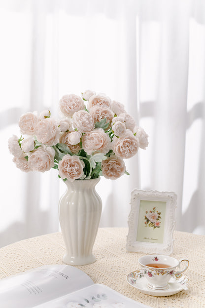 Pretty and life-like light-pink Ranunculus flowers with green realistic leaves, fancy a fresh from the garden feel.