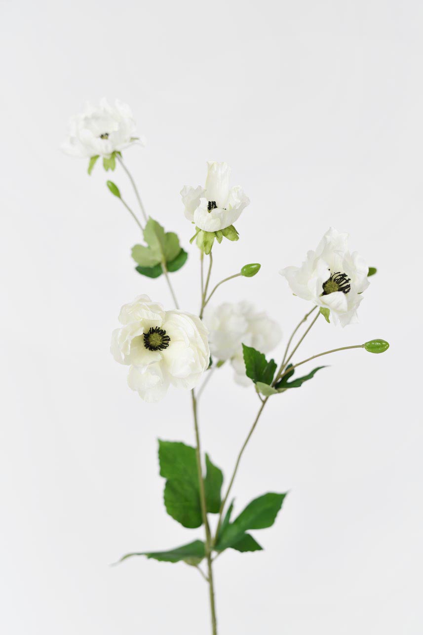 A bouquet of cream and white fake anemone flowers, 37 inches tall with green leaves.