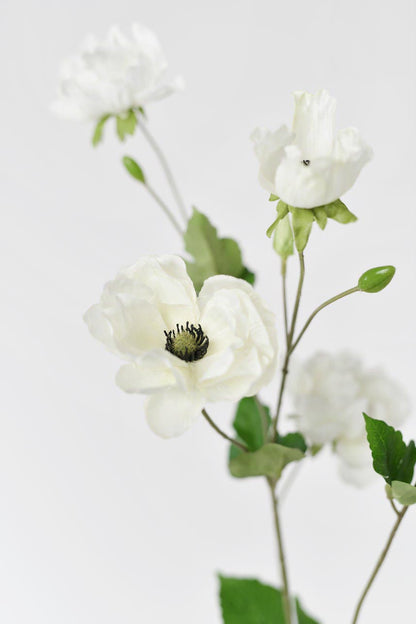 A cream and white fake anemone flower with realistic-looking petals, 37 inches tall.