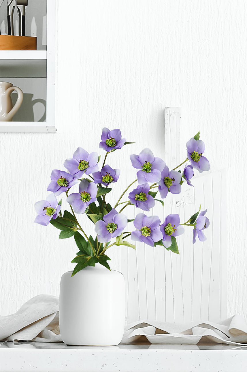 The light purple helleborus has a unique elegance and the faux petals are naturally colored with a stunning charm. Place it in a white vase and make it a unique work of art.