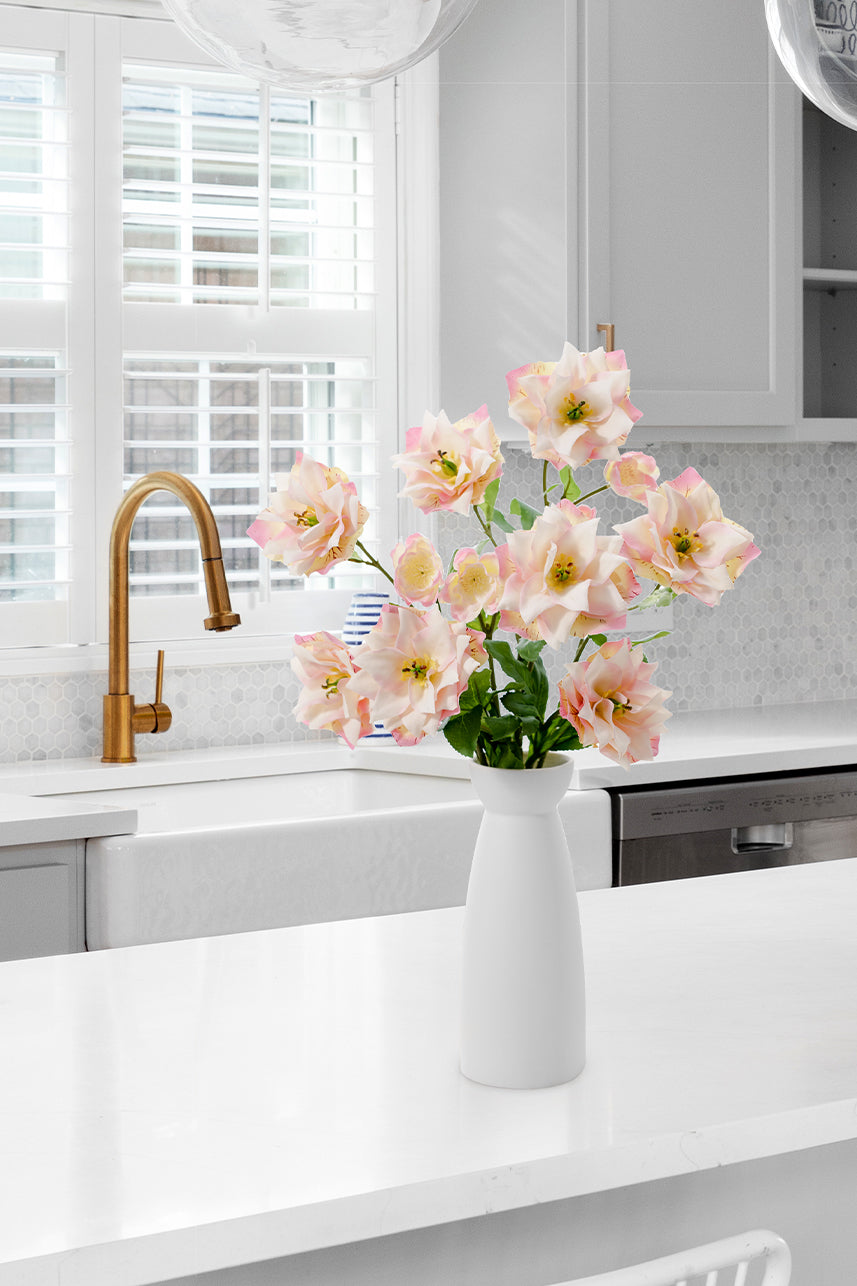 When placed in a white kitchen, the mauve pink clematis adds life to the scene and is perfect as a home centerpiece.
