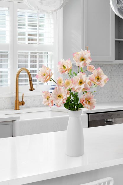 When placed in a white kitchen, the mauve pink clematis adds life to the scene and is perfect as a home centerpiece.