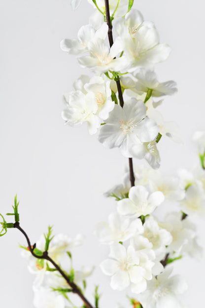 Hand-crafted cream white cherry blossom flowers with realistic colors, white petals and yellow central stamens.