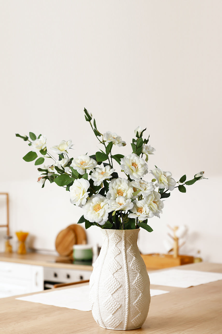 The creamy-white artificial iceberg rose flower is suitable for a warm and comfortable home decor, and the faux flowers look more fresh and natural against the branches and leaves.