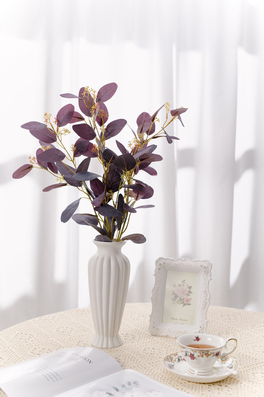Artificial real-looking artificial Burgundy Parisian Eucalyptus arrangements in a white vase, adding natural charm to any space.
