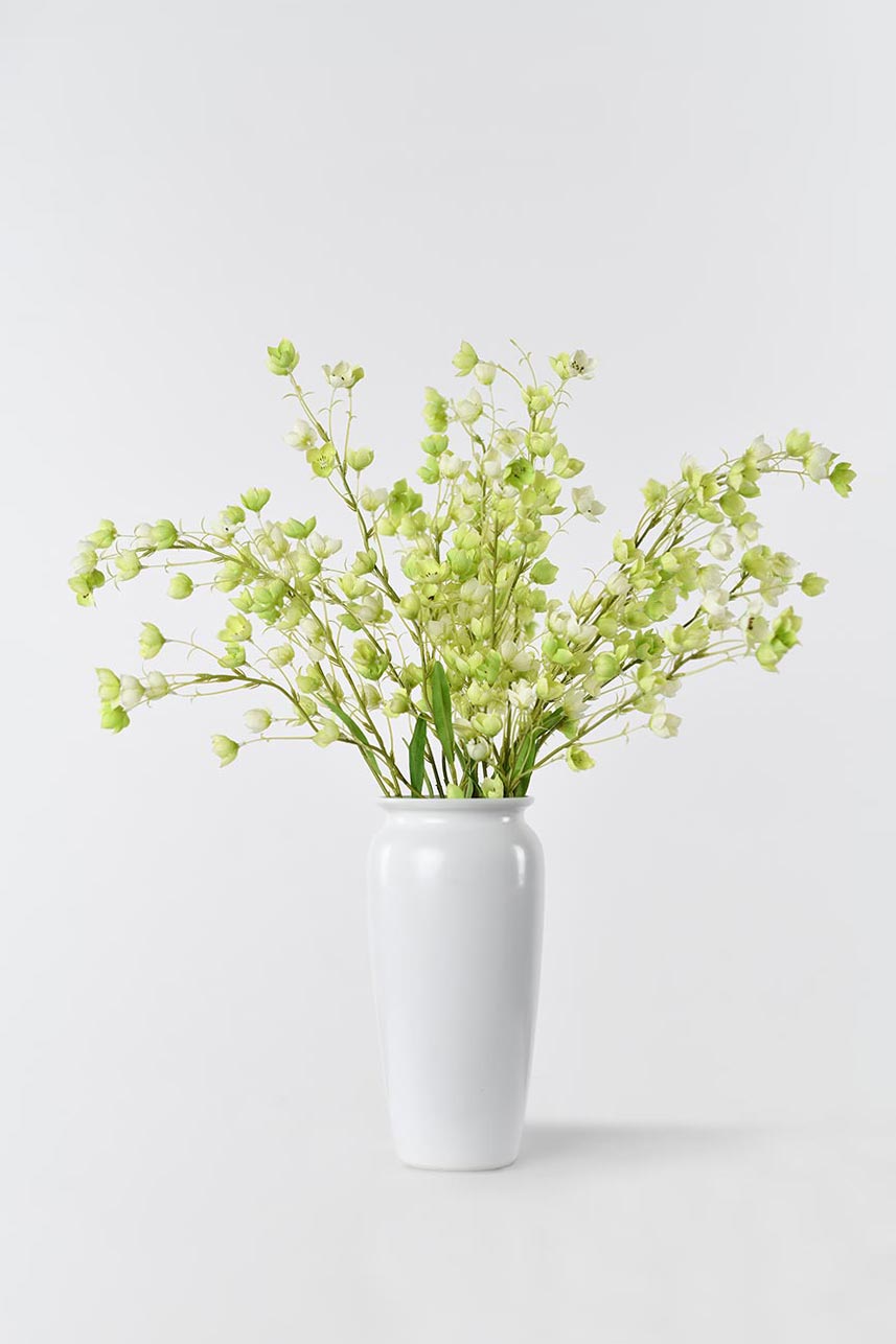 Artificial Enkianthu flower in full bloom, arranged in a white vase