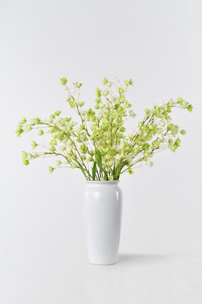 Artificial Enkianthu flower in full bloom, arranged in a white vase