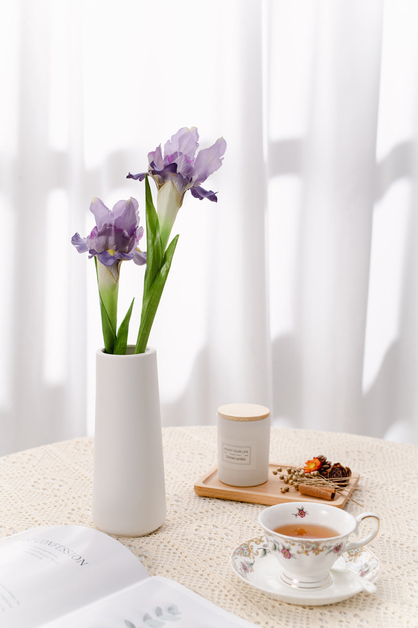 Two fake purple Iris Silk flowers arrangement in a white vase, decor on the coffe table, adding natural charm to any space.