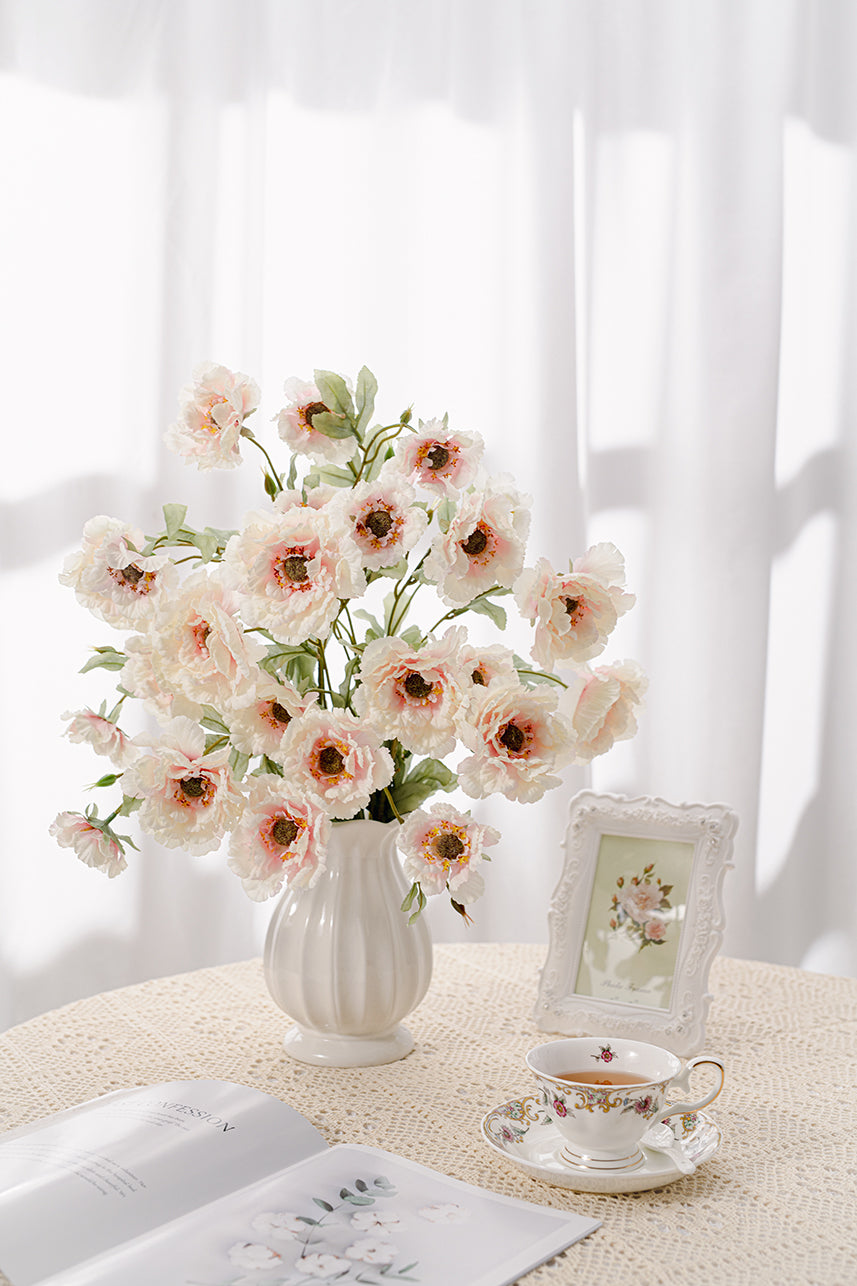 The budding to full bloom artificial soft pink lotus crane peony fake flowers are complete with a white vase perfect as a centerpiece.