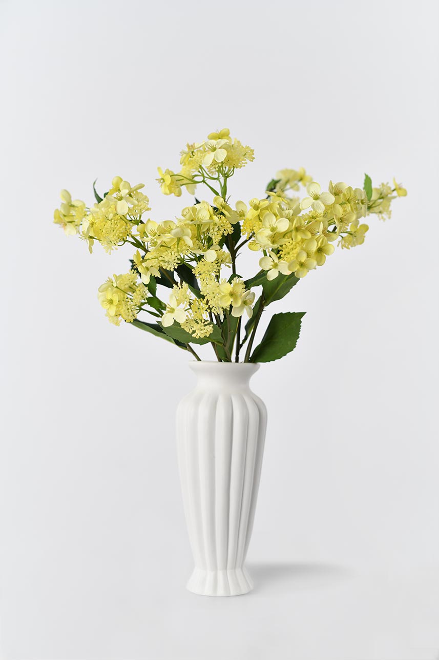 Faux yellow Hydrangea Hortensia silk flowers, 27-inch tall, blooming in white vase.