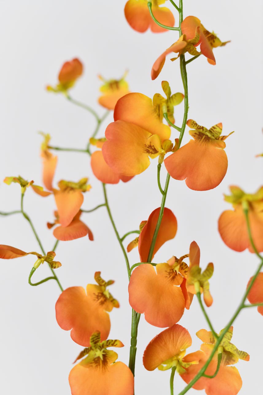 Artificial orange dancing orchid silk flowers with realistic-looking petals and textures. The flowers are arranged in a way that looks natural and lifelike, adding a touch of nature to any space.