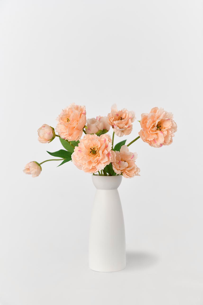 Peach artificial peony flowers with a faux, realistic-looking appearance and 21-inch faux-floral stems