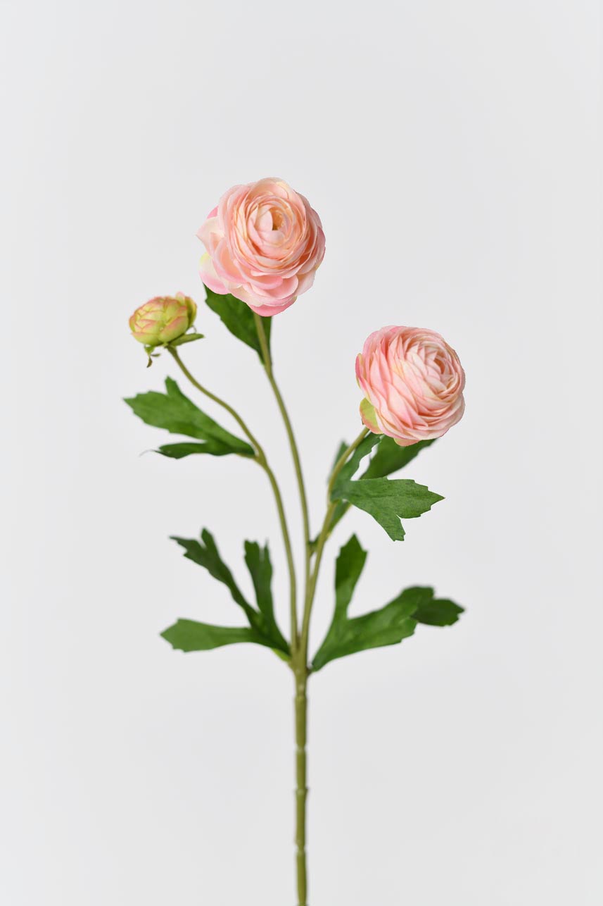 Realistic artificial silk flower in rose pink with bright green leaves and petals.