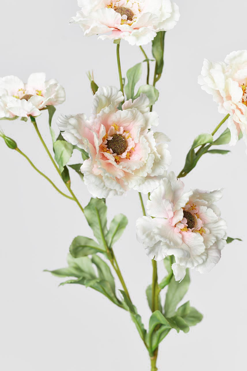 A close-up detail of soft pink lotus crane peony fake flowers with green leaves, adding a chic touch to your home.