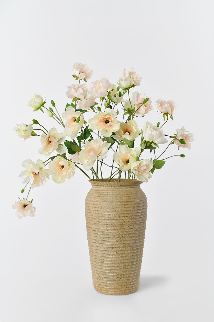 A clear vase filled with beautiful yellow and peach artificial anemone flowers, arranged in an eye-catching display. Stands at 37 inches in height.